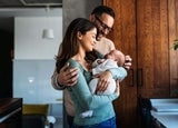 Mother and father holding a baby